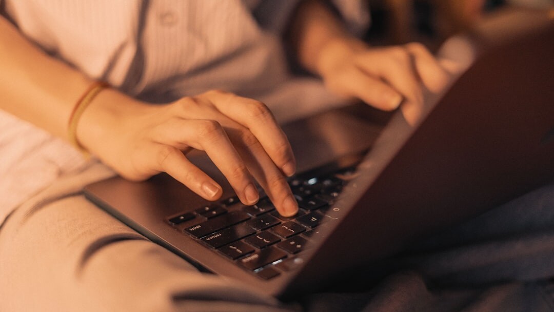 mystery writer typing on laptop